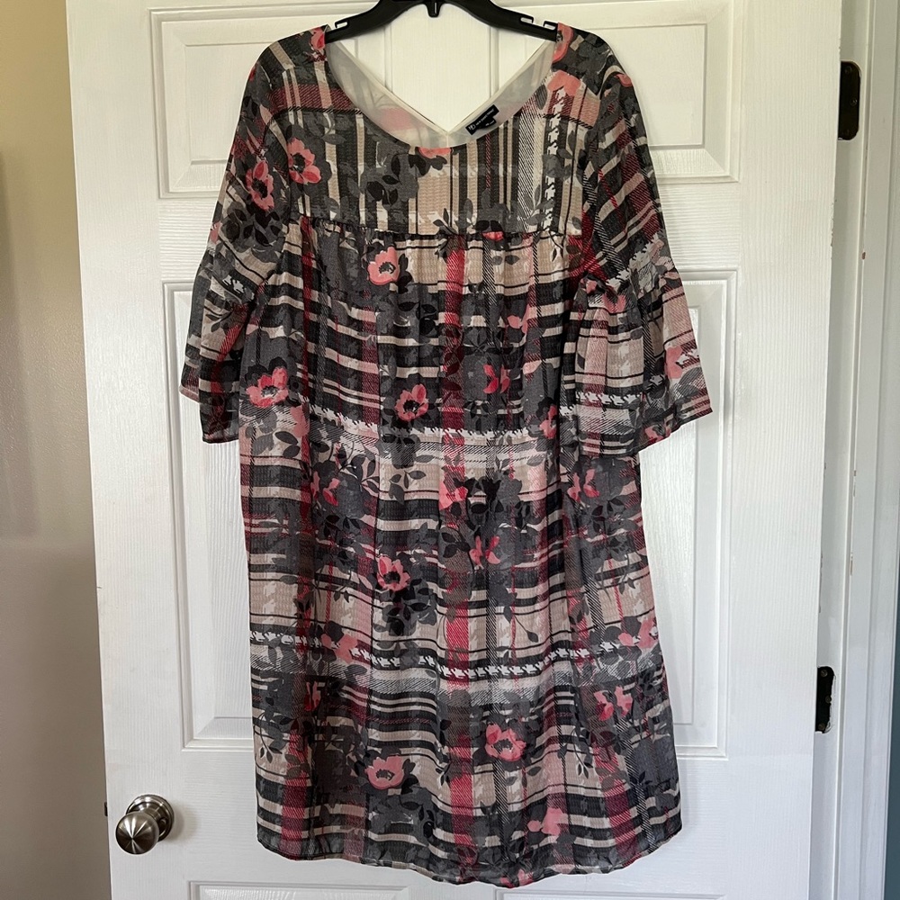 Tan and gray lined dress with pink floral print and elbow length bell sleeves.
